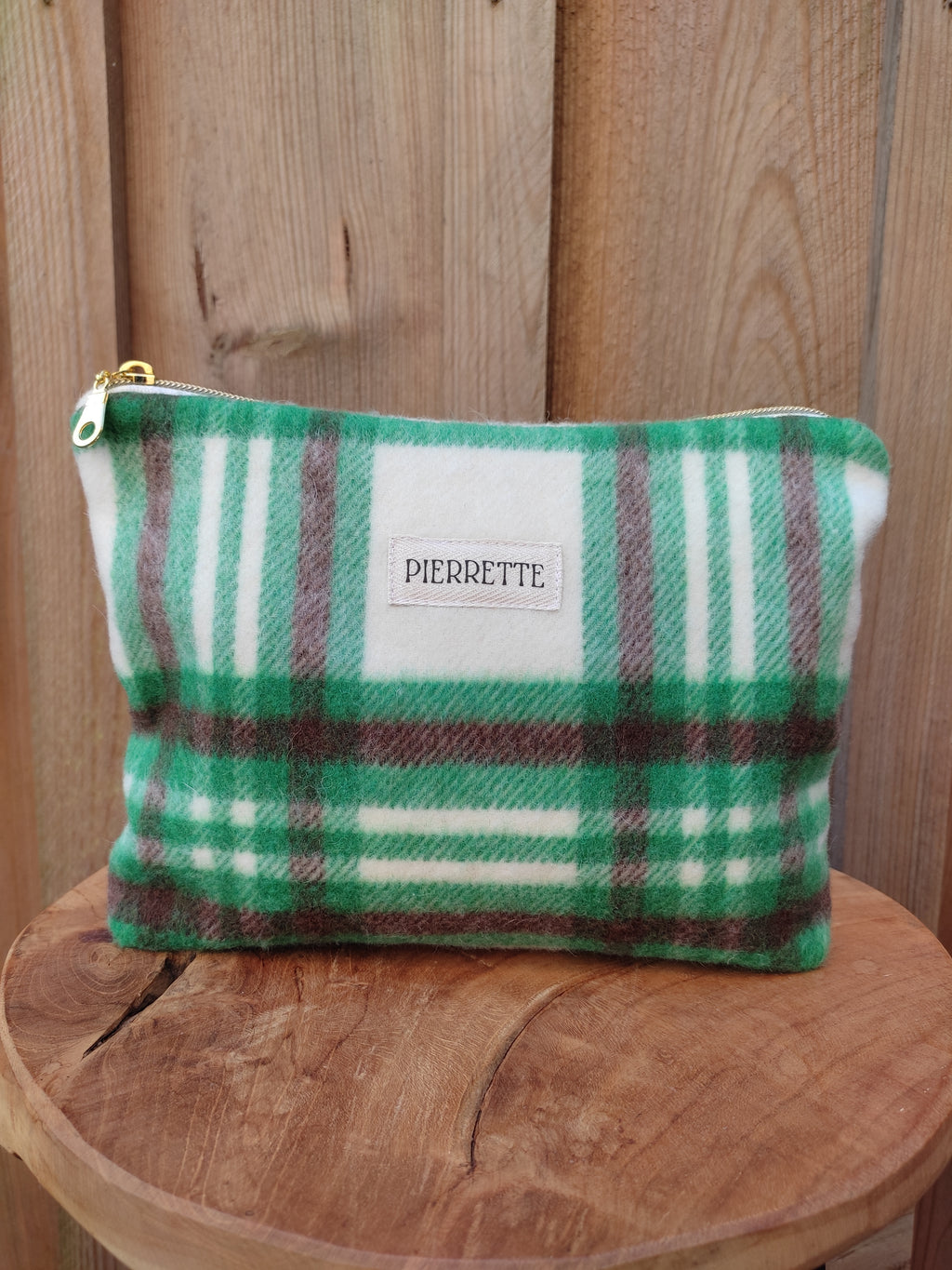 Pochette Azalée 25 cm x 18 cm avec une profondeur de 4 cm. Elle est présentée ici de face, elle est confectionnée dans un lainage à carreaux ver, marron et écru.